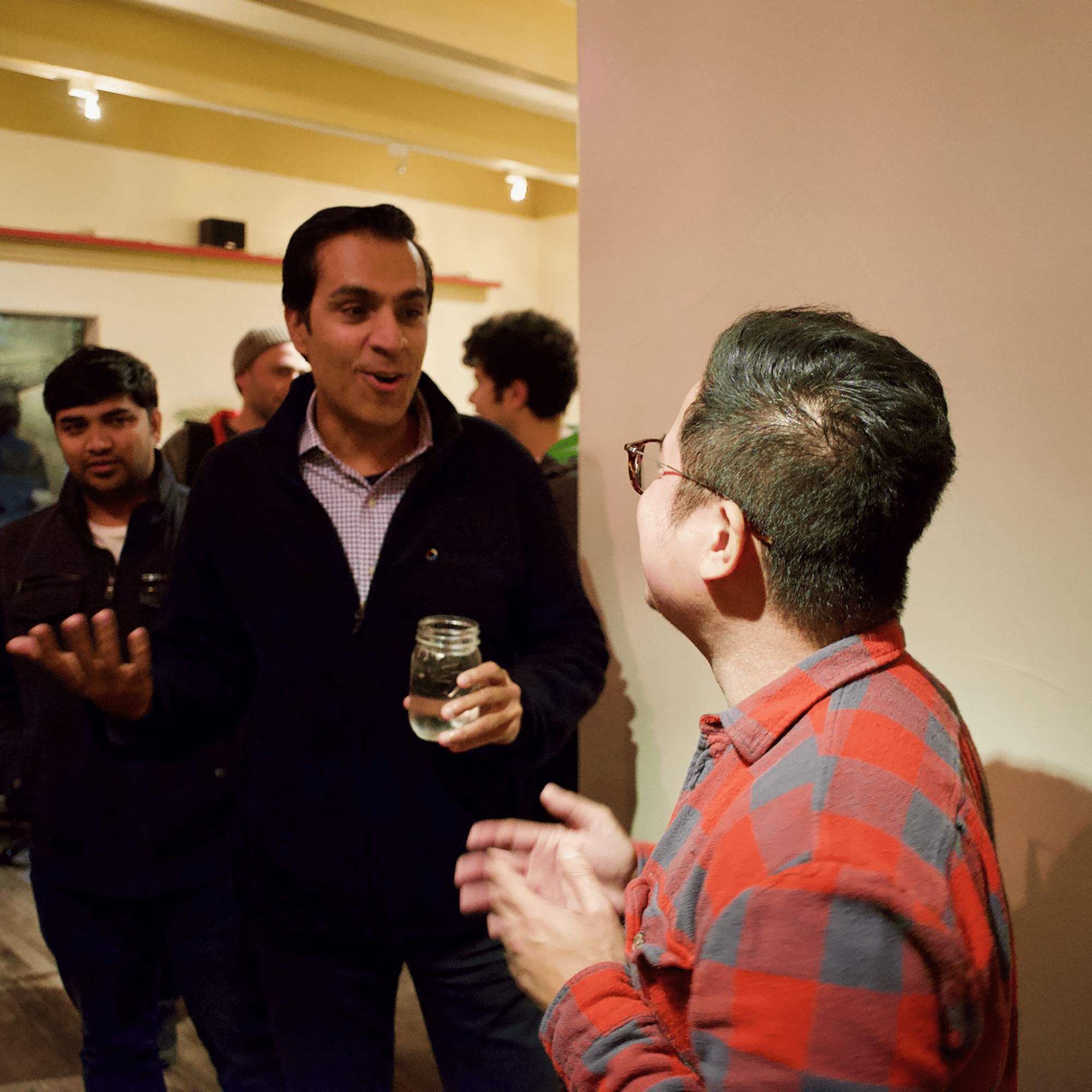 Anil chatting with Tim during dinner